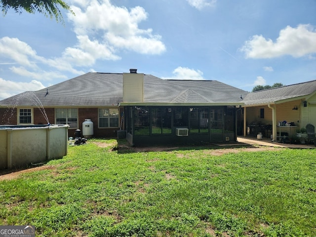 115 Settlers Trl, Warner Robins, GA 31088 - back of property featuring a lawn, an outdoor pool, a chimney, and a sunroom