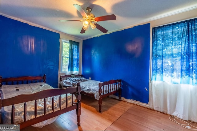 1115 W 51st St, Savannah, GA 31405 - bedroom featuring crown molding, wood finished floors, and a ceiling fan