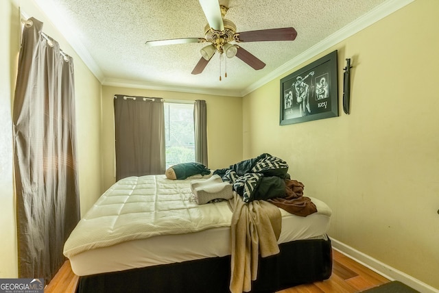 1115 W 51st St, Savannah, GA 31405 - bedroom featuring wood finished floors, a textured ceiling, a ceiling fan, and crown molding