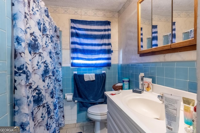 1115 W 51st St, Savannah, GA 31405 - bathroom featuring tile walls, a textured ceiling, vanity, tile patterned flooring, and a shower with shower curtain