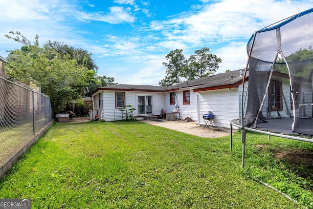 1115 W 51st St, Savannah, GA 31405 - rear view of house featuring a trampoline, a patio, and a fenced backyard