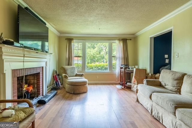 1115 W 51st St, Savannah, GA 31405 - living area with hardwood / wood-style flooring, a textured ceiling, a brick fireplace, and ornamental molding