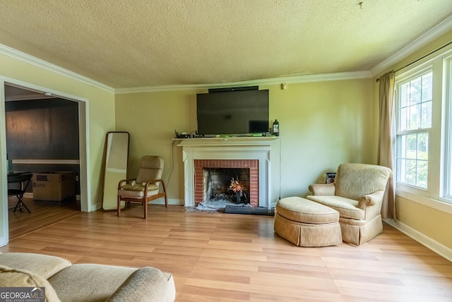 1115 W 51st St, Savannah, GA 31405 - living area featuring a textured ceiling, plenty of natural light, light wood-type flooring, crown molding, and a fireplace