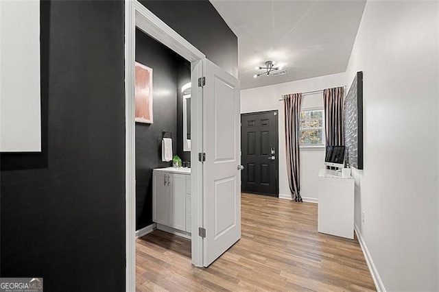 4992 Lower Elm, Atlanta, GA 30349 - corridor with light wood-style floors and baseboards