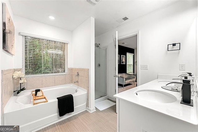 4992 Lower Elm, Atlanta, GA 30349 - bathroom with a garden tub, double vanity, and a stall shower