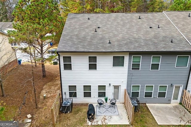 4992 Lower Elm, Atlanta, GA 30349 - back of property with a patio area, roof with shingles, and a fenced backyard