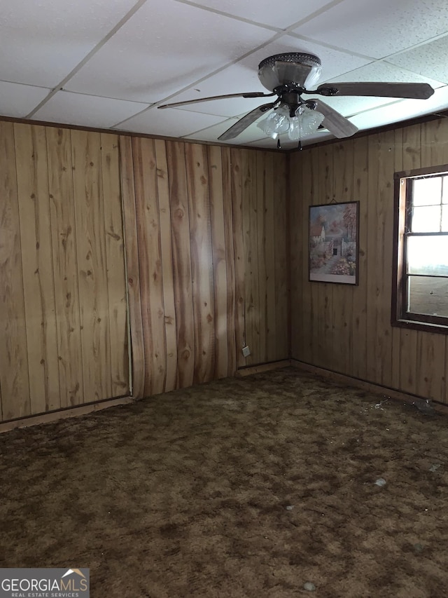 2712 Maple Rd SE, Rome, GA 30161 - unfurnished room with dark colored carpet, wooden walls, and ceiling fan