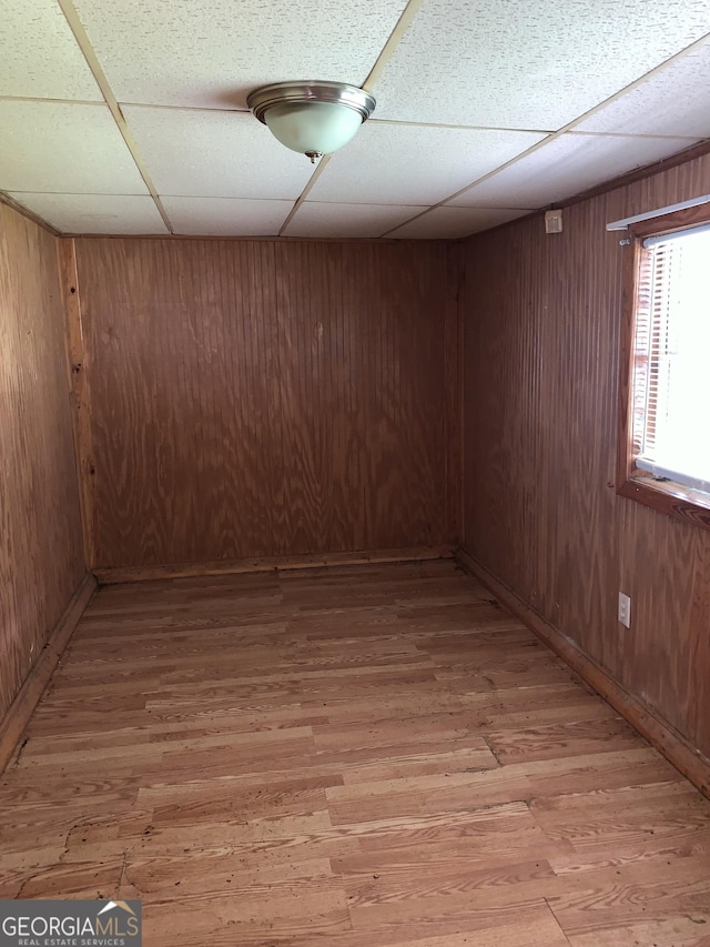 2712 Maple Rd SE, Rome, GA 30161 - below grade area featuring light wood-type flooring, a drop ceiling, and wooden walls