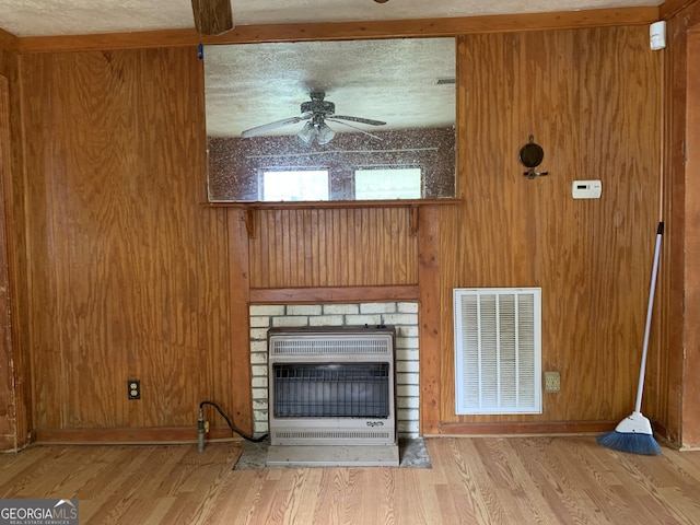 2712 Maple Rd SE, Rome, GA 30161 - unfurnished living room featuring heating unit, a ceiling fan, wood finished floors, and a brick fireplace