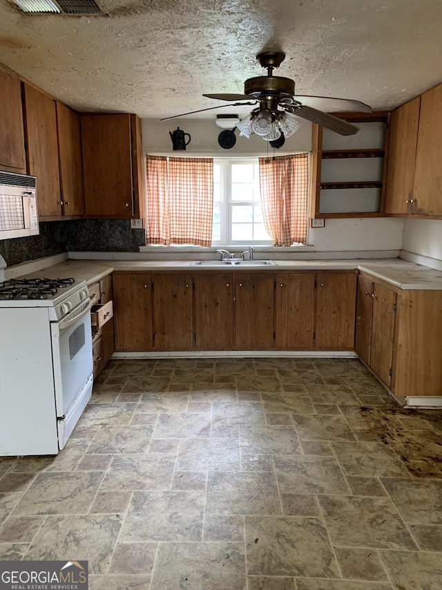 2712 Maple Rd SE, Rome, GA 30161 - kitchen with white appliances, ceiling fan, light stone finish floors, light countertops, and open shelves