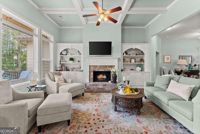6460 Valley Crossing Way, Cumming, GA 30028 - living room featuring coffered ceiling, a ceiling fan, a brick fireplace, beamed ceiling, and built in shelves