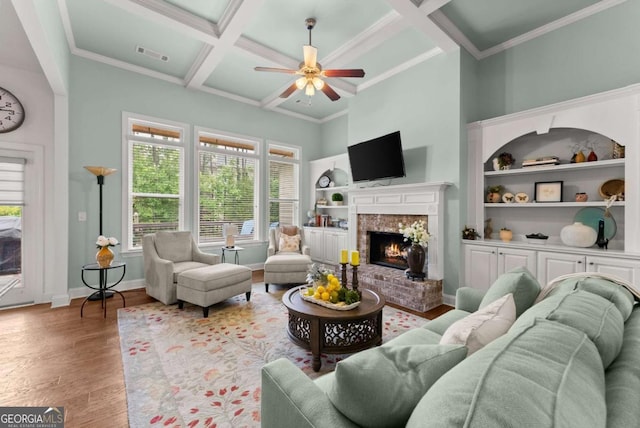 6460 Valley Crossing Way, Cumming, GA 30028 - living area with a ceiling fan, wood finished floors, coffered ceiling, a brick fireplace, and ornamental molding