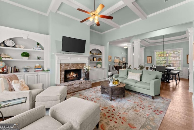 6460 Valley Crossing Way, Cumming, GA 30028 - living area featuring wood finished floors, ceiling fan, built in features, coffered ceiling, and crown molding