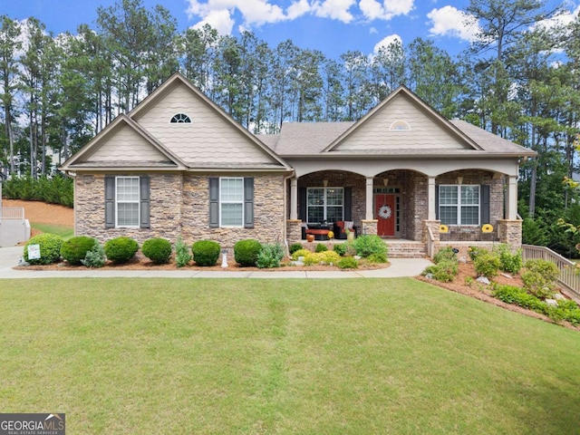 6460 Valley Crossing Way, Cumming, GA 30028 - craftsman-style home with covered porch, a front yard, and stone siding