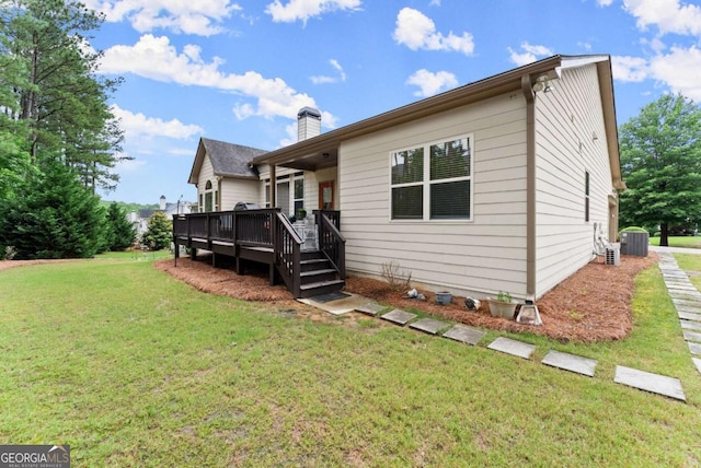 6460 Valley Crossing Way, Cumming, GA 30028 - back of house with a wooden deck, a lawn, and a chimney