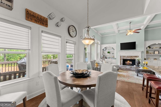 6460 Valley Crossing Way, Cumming, GA 30028 - dining space featuring coffered ceiling, a ceiling fan, a brick fireplace, dark wood finished floors, and beam ceiling