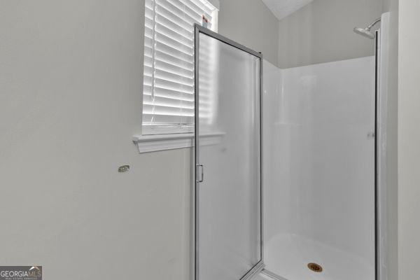 7770 Hana Ct, Jonesboro, GA 30236 - bathroom featuring a stall shower