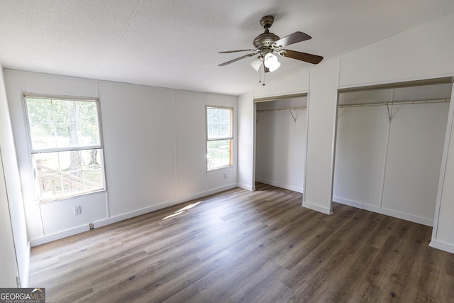 179 Autumnwood Way, Cleveland, GA 30528 - unfurnished bedroom featuring multiple closets, wood finished floors, a textured ceiling, and ceiling fan