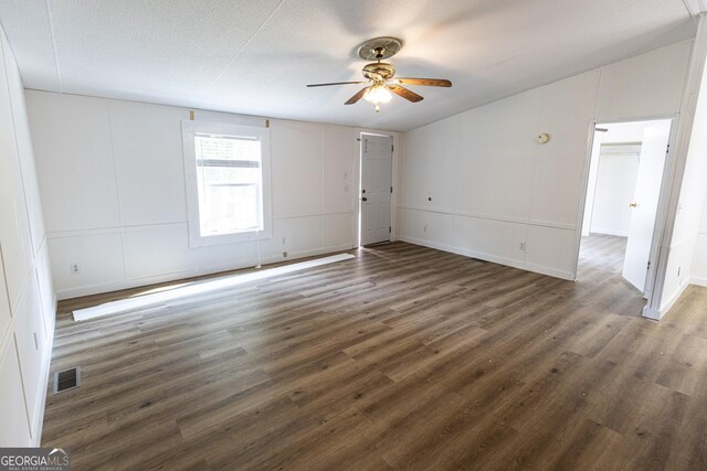 179 Autumnwood Way, Cleveland, GA 30528 - unfurnished room featuring ceiling fan, a decorative wall, dark wood-type flooring, and lofted ceiling