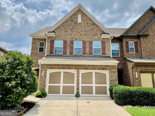 3534 Clancy Way, Smyrna, GA 30080 - view of front of house with concrete driveway, a garage, brick siding, and roof with shingles
