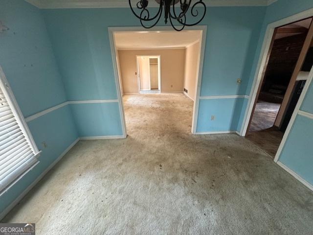 3415 Spring Valley Blvd, South Fulton, GA 30349 - unfurnished dining area featuring carpet floors, a chandelier, and ornamental molding