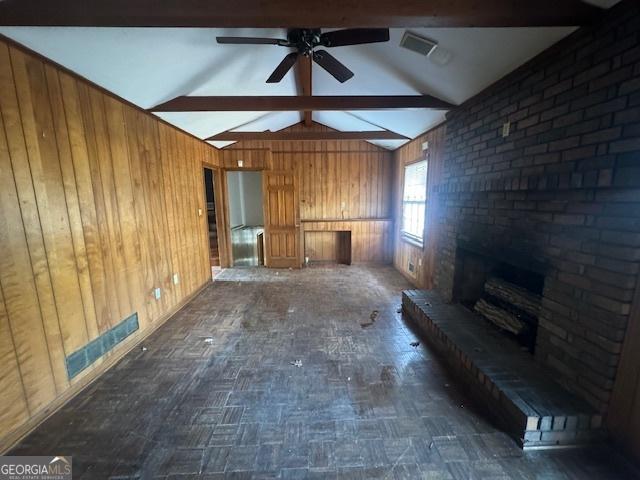 3415 Spring Valley Blvd, South Fulton, GA 30349 - unfurnished living room featuring wooden walls, ceiling fan, and a fireplace