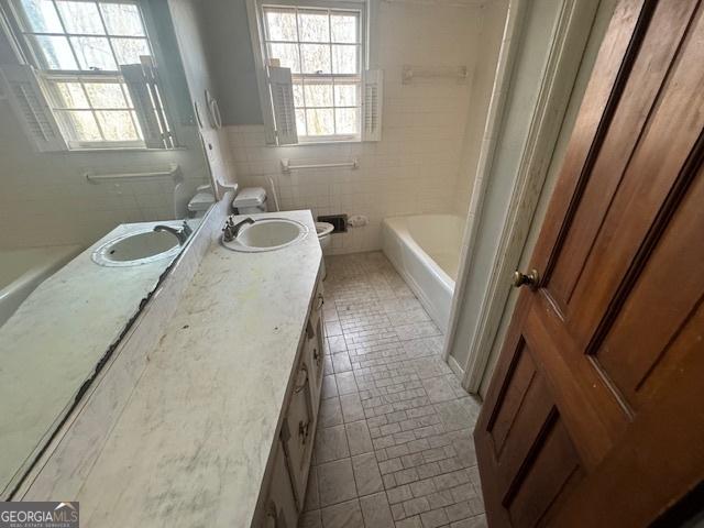 3415 Spring Valley Blvd, South Fulton, GA 30349 - bathroom with double vanity, tile walls, and tile patterned floors