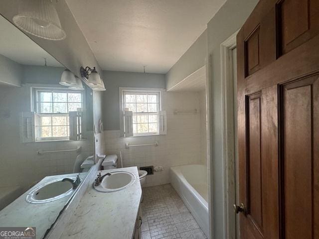 3415 Spring Valley Blvd, South Fulton, GA 30349 - bathroom featuring vanity, tile walls, and tub / shower combination