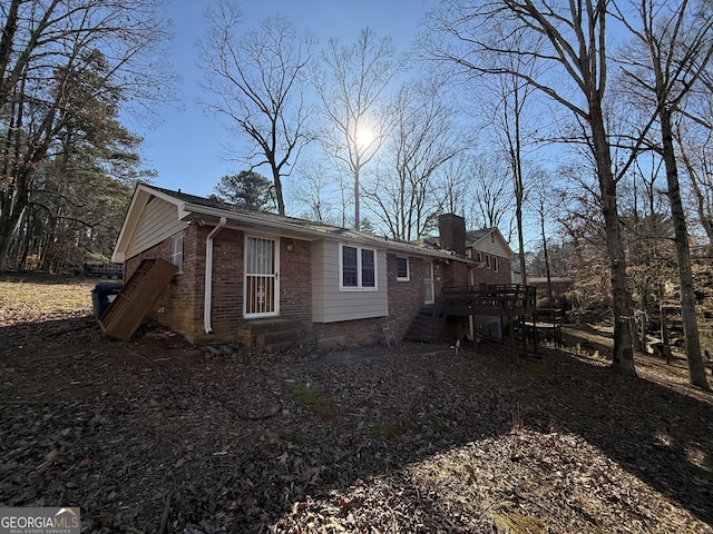 3415 Spring Valley Blvd, South Fulton, GA 30349 - view of property exterior with brick siding, a deck, a chimney, and stairway