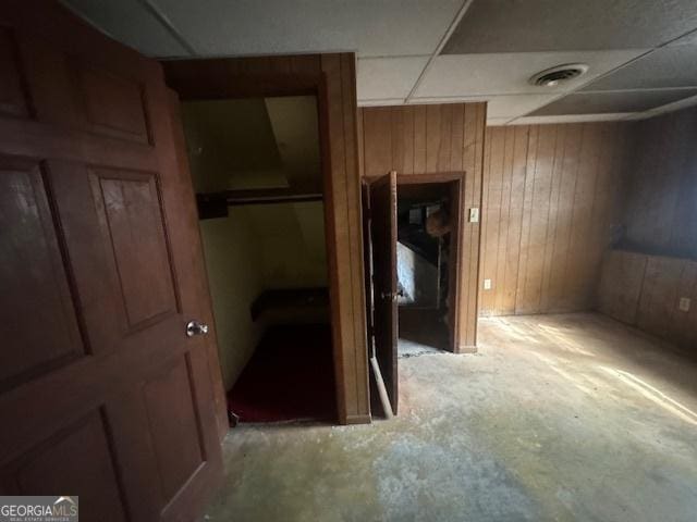3415 Spring Valley Blvd, South Fulton, GA 30349 - hall featuring wooden walls, concrete floors, and a drop ceiling