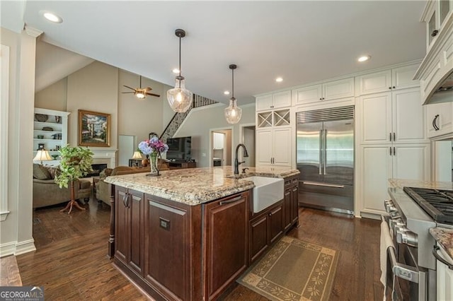 660 Glendalough Ct, Alpharetta, GA 30004 - kitchen with high end appliances, white cabinetry, a ceiling fan, light stone counters, and dark brown cabinets