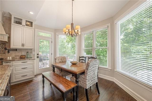 660 Glendalough Ct, Alpharetta, GA 30004 - dining area with healthy amount of natural light, a chandelier, and dark wood-style flooring
