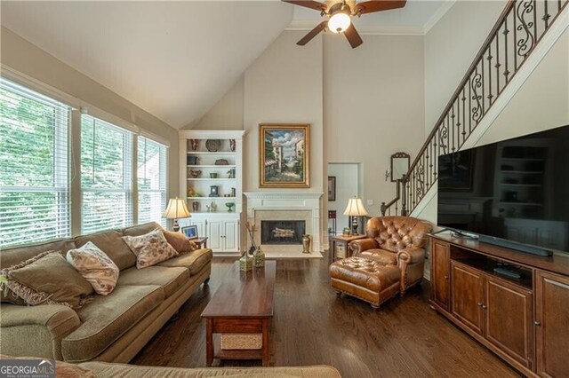 660 Glendalough Ct, Alpharetta, GA 30004 - living area featuring a ceiling fan, high vaulted ceiling, a fireplace with raised hearth, built in features, and stairs