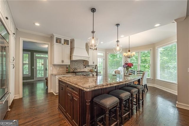 660 Glendalough Ct, Alpharetta, GA 30004 - kitchen featuring premium range hood, dark wood-style floors, plenty of natural light, recessed lighting, and ornamental molding