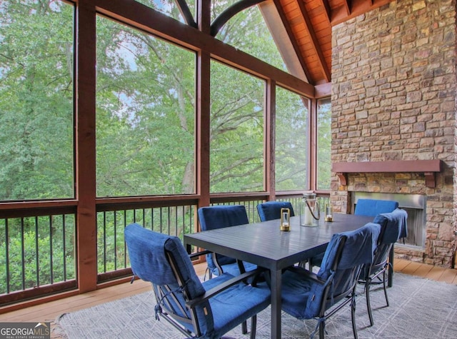 3467 Brookleigh Ln NE, Atlanta, GA 30319 - sunroom / solarium featuring a stone fireplace, outdoor dining area, and plenty of natural light