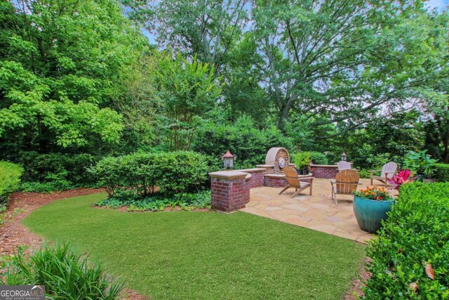 3467 Brookleigh Ln NE, Atlanta, GA 30319 - view of grassy yard with a patio