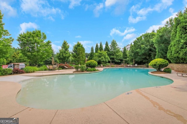 3467 Brookleigh Ln NE, Atlanta, GA 30319 - community pool with a patio area and view of scattered trees