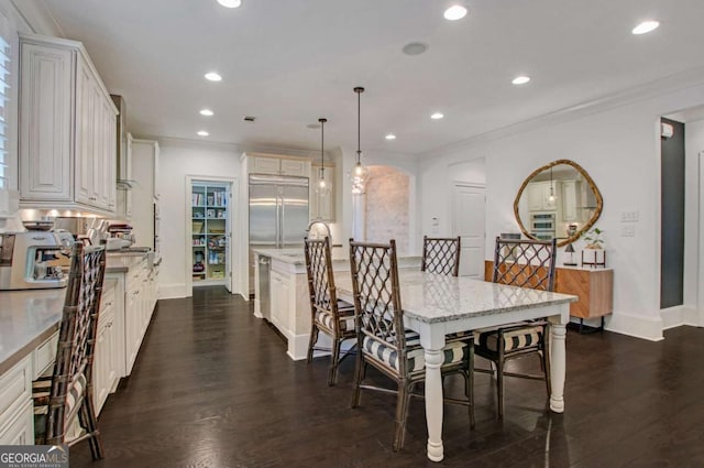 3467 Brookleigh Ln NE, Atlanta, GA 30319 - dining area with recessed lighting, dark wood finished floors, ornamental molding, and arched walkways