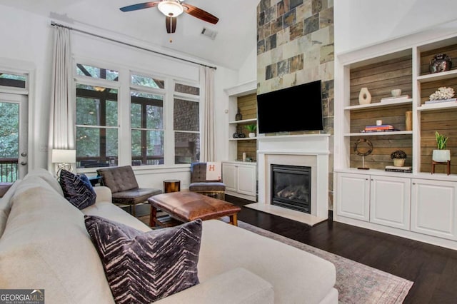 3467 Brookleigh Ln NE, Atlanta, GA 30319 - living area with a ceiling fan, dark wood-style flooring, a fireplace, built in shelves, and high vaulted ceiling