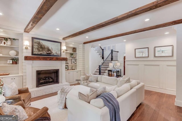 120 Slate Dr, Buford, GA 30518 - living room featuring stairway, wood-type flooring, beamed ceiling, a fireplace, and built in features