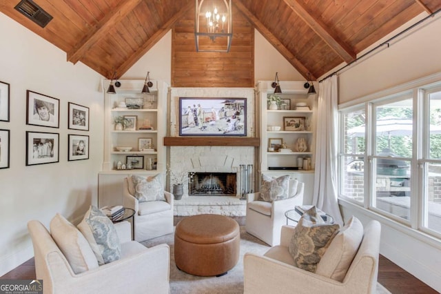 120 Slate Dr, Buford, GA 30518 - living room with a wooden ceiling with exposed beams, a chandelier, a stone fireplace, high vaulted ceiling, and wood finished floors