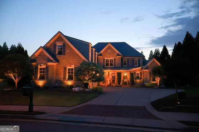 120 Slate Dr, Buford, GA 30518 - view of front of home with a front lawn, curved driveway, and brick siding