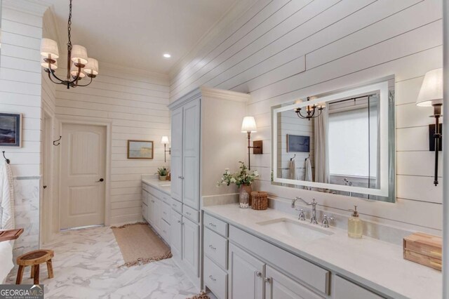 120 Slate Dr, Buford, GA 30518 - bathroom with a chandelier, vanity, marble look tile flooring, wooden walls, and crown molding