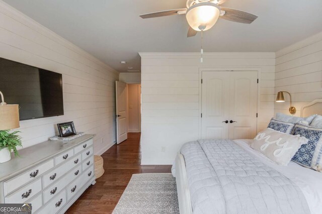120 Slate Dr, Buford, GA 30518 - bedroom featuring wood walls, dark wood-style floors, a closet, and a ceiling fan