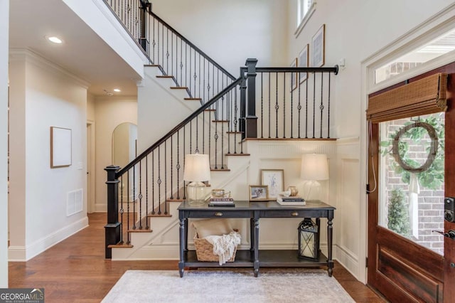 120 Slate Dr, Buford, GA 30518 - foyer entrance featuring healthy amount of natural light, a high ceiling, wood finished floors, stairway, and arched walkways