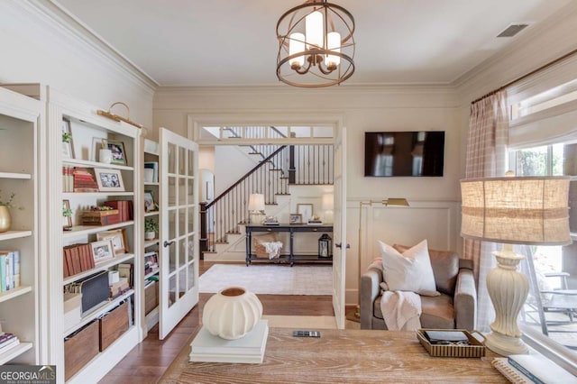 120 Slate Dr, Buford, GA 30518 - sitting room featuring french doors, wood finished floors, stairway, ornamental molding, and a chandelier