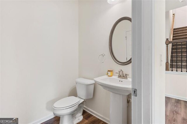 3390 Meadow Grass Dr, Dacula, GA 30019 - half bathroom with wood finished floors and toilet