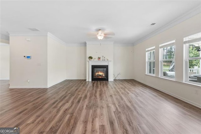 3390 Meadow Grass Dr, Dacula, GA 30019 - unfurnished living room featuring ceiling fan, wood finished floors, a warm lit fireplace, and ornamental molding