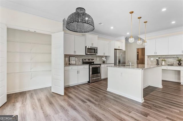 3390 Meadow Grass Dr, Dacula, GA 30019 - kitchen featuring appliances with stainless steel finishes, backsplash, white cabinets, ornamental molding, and recessed lighting