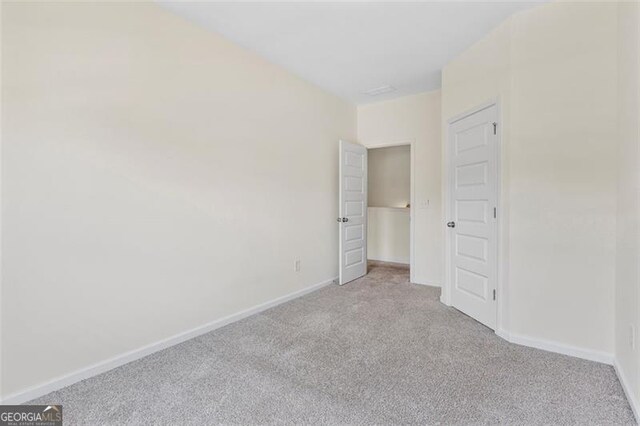 3390 Meadow Grass Dr, Dacula, GA 30019 - unfurnished bedroom featuring carpet floors and baseboards